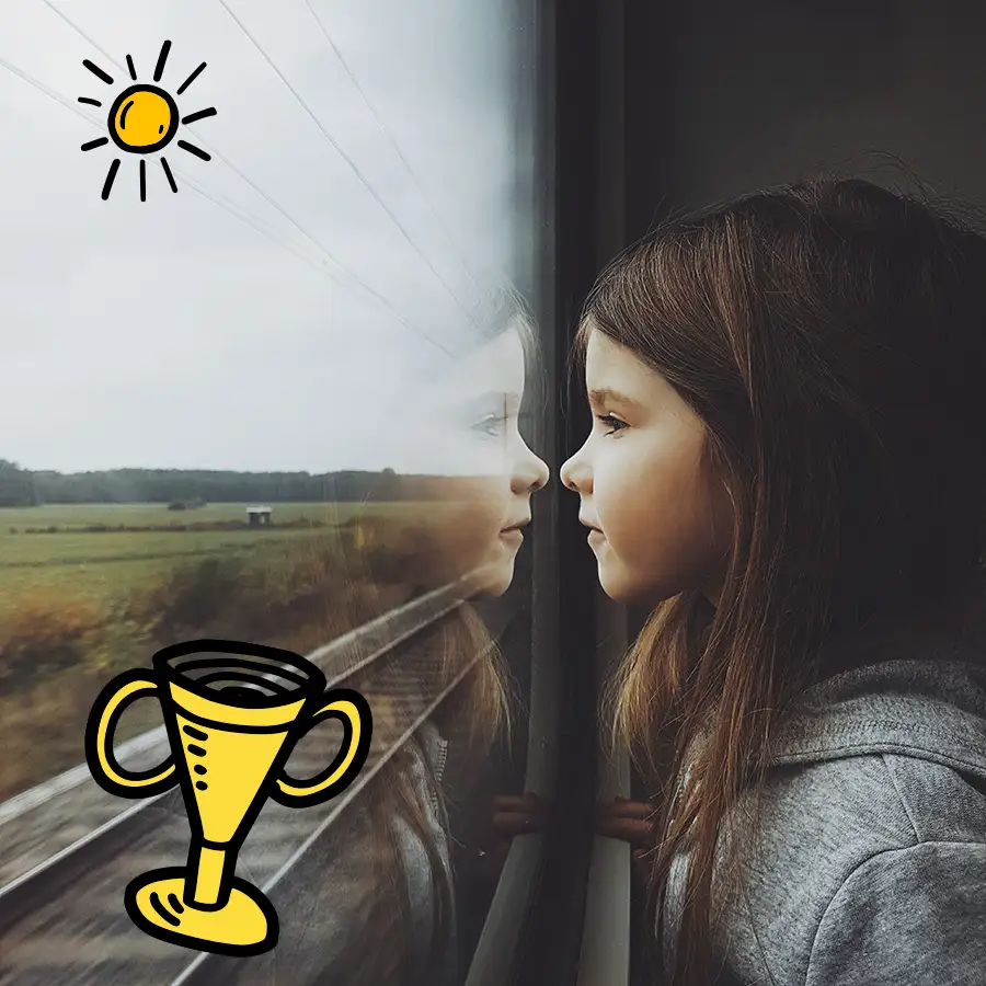 Mädchen schaut aus einem Zugfenster
